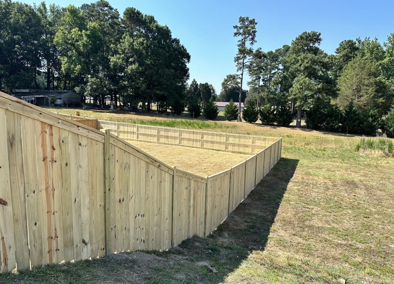 Custom wood privacy fence enclosing a large yard