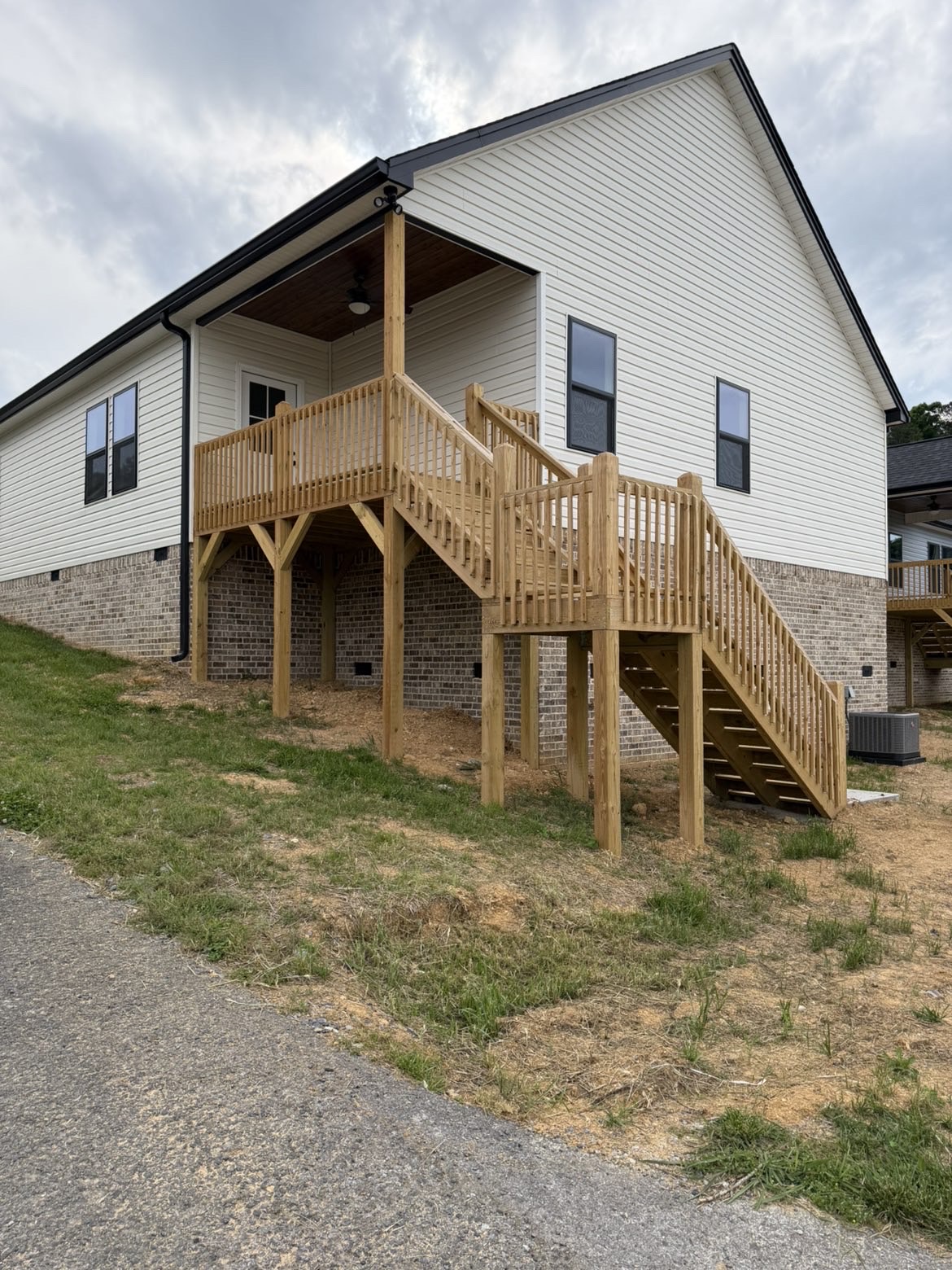 Wraparound deck with wood railing and staircase